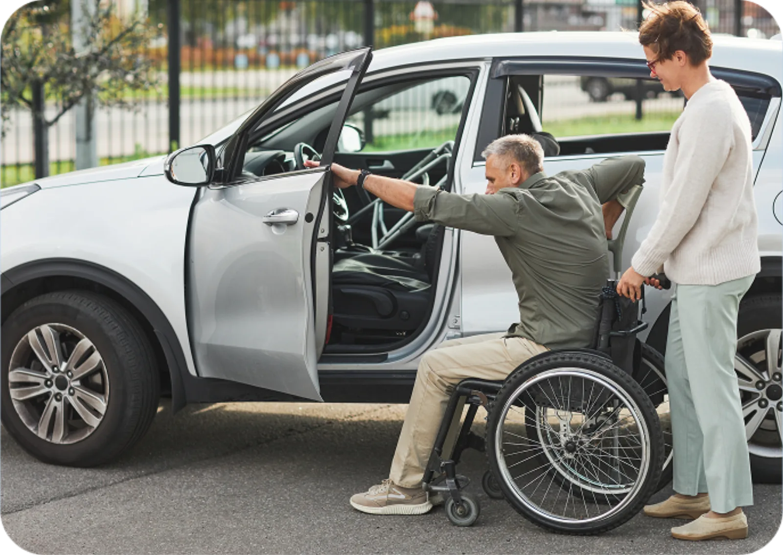 Noon Care support worker assisting an NDIS participant with safely transferring into a vehicle for a transport and travel assistance service